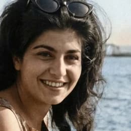 A close crop of her face from the restored photo before upscaling, soft and blurry