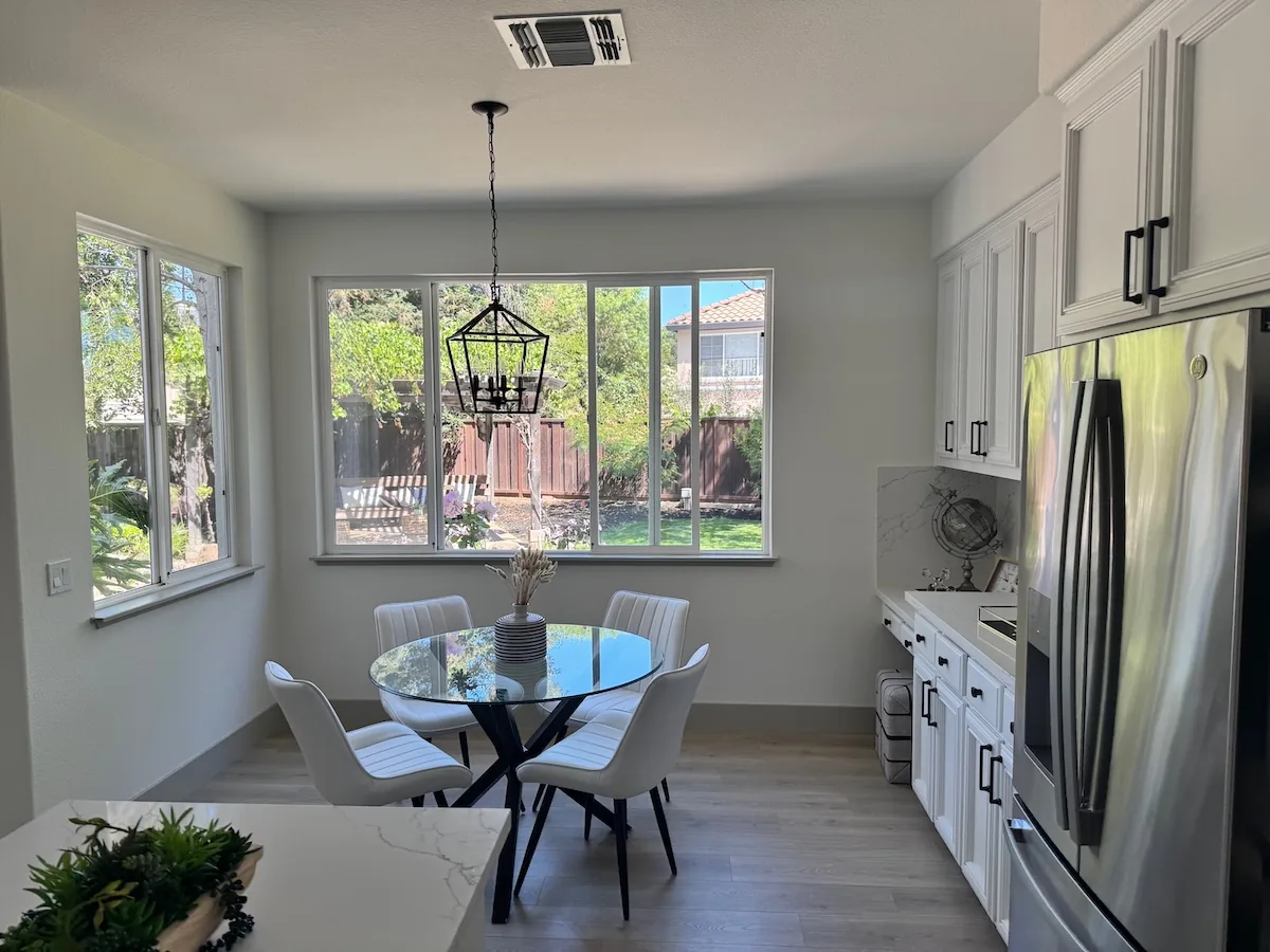Official OpenAI source kitchen photograph with four white dining chairs